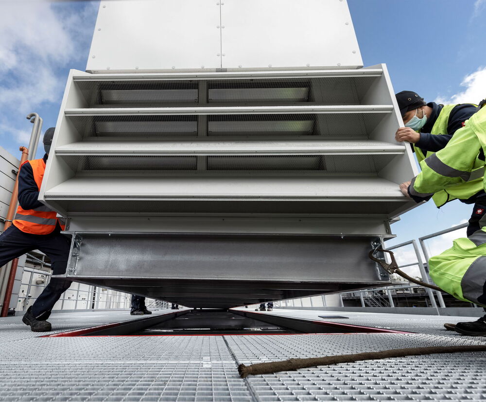 Just another 10 centimeters before the air handling unit is entirely in place. Just another 10 centimeters before the air handling unit is entirely in place.
